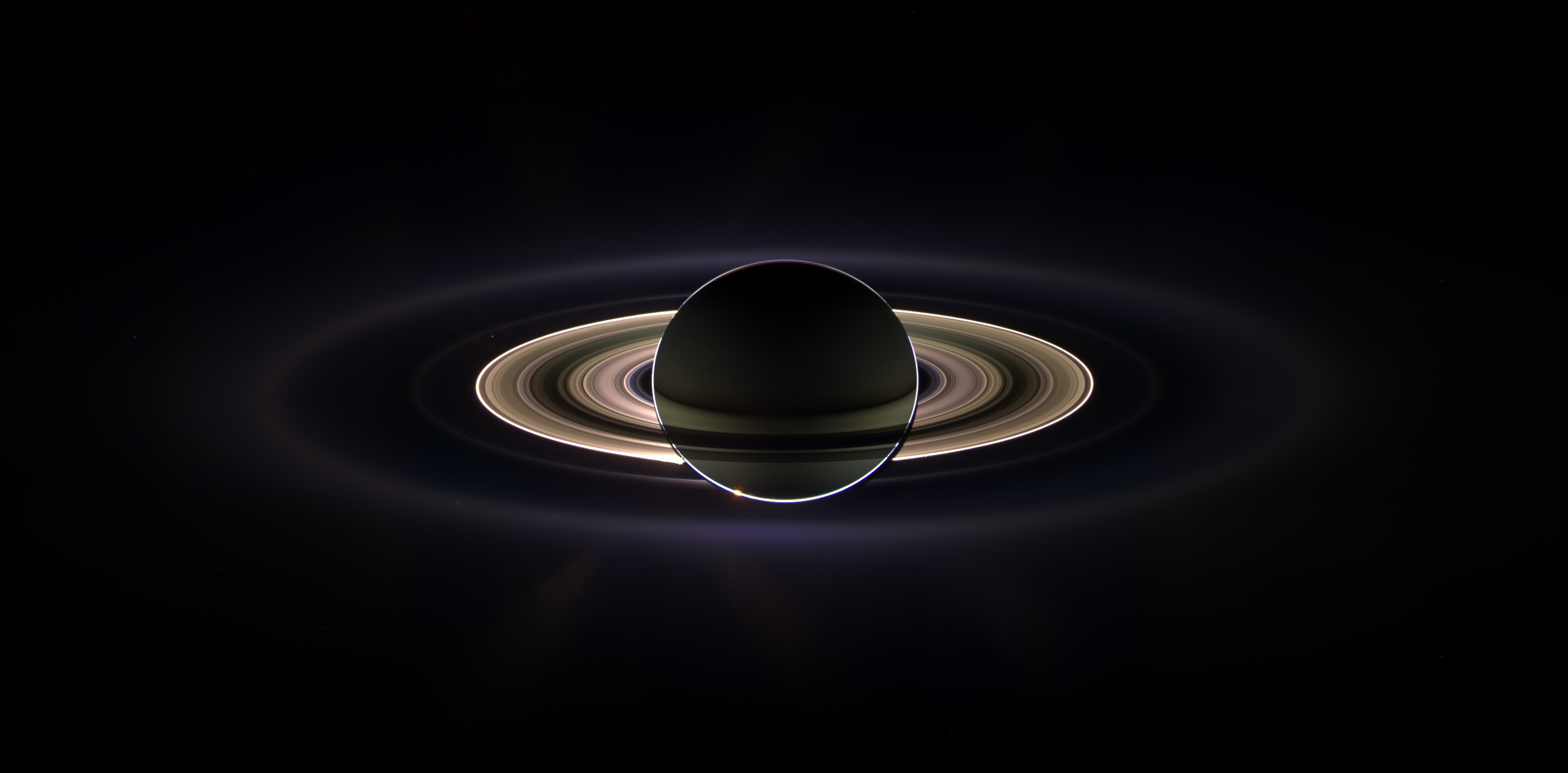 Saturn backlit by the sun.